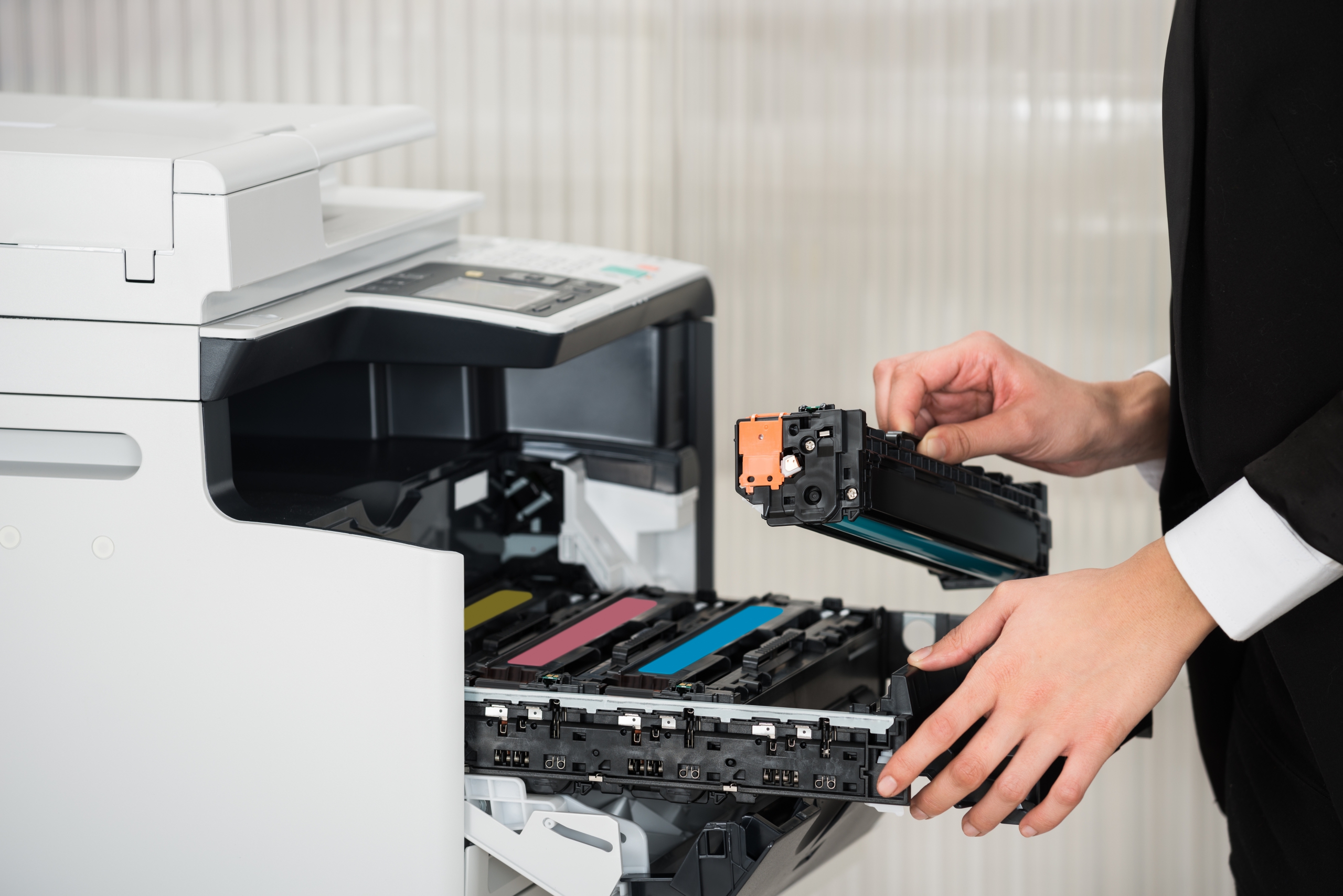 Businessman Fixing Cartridge In Printer Machine At Office